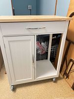 front view showing butcher block top, drawer, door, open compartment
