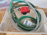 Pump, hoses and manual in plastic bin