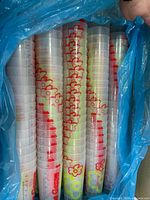 Stacks of clear promo cups in blue liner bag