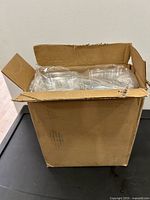 Closed cardboard box holding plastic cupcake containers