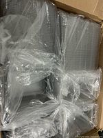 Stack of clear plastic containers packed in box