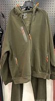 Full view of jacket on hanger with pants partially visible
