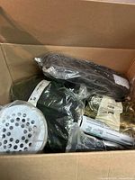 Overview of box contents showing perforated disc and plastic-wrapped items