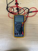 Front view of multimeter with leads wrapped around unit powered off