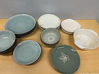 Group view of assorted plates and bowls on table
