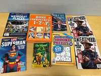 All eight printed items laid out on table