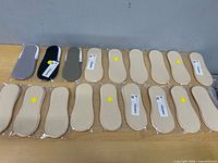 Full lot of 20 packaged no-show socks in two rows on table