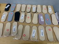 Overview of all sealed sock packs laid out on table