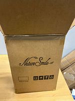 Closed shipping box with Nature Smile branding