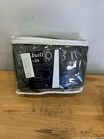 Front view of packaged SHINELAND olive green blackout curtains