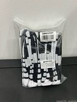 Factory-sealed package containing five pairs of black and white crew basketball socks