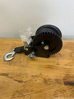 Side view of TYT hand winch showing strap and hook