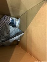 Overview of box with bagged garments