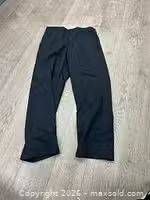 Full view of one pair of dark cargo work pants