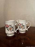 Three of the four floral bone china teacups grouped on tabletop