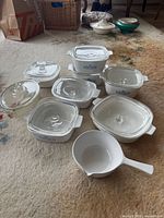 Overview of all CorningWare pieces on carpet
