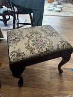 Close view of square footstool upholstery and legs