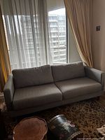 Front view of grey sofa showing overall design and upholstery