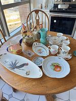 Overview of entire lot on table showing all ceramics and glassware
