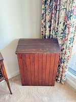 Closed chest showing vertical slat front and natural finish