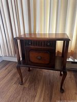 Full view of vintage wood side table showing drawer, cabinet door and cabriole legs