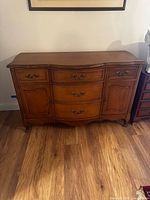 Full front view of buffet showing drawers, cabinet doors, legs, hardware