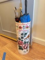 Front view of stand showing floral and bird design with umbrellas inside