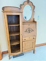 Front view showing entire secretary desk with bookcase, mirror, drop-front, and lower door