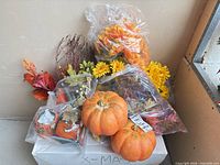 All items together on box: faux flowers, twig spray, pumpkins