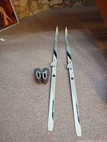 Pair of Karhu skis and boots laid out together