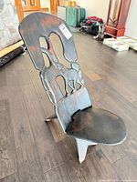 Full view of carved wood chair from side angle