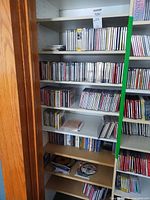 Shelved collection of CDs across five shelves