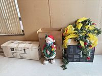 All three items: boxed tree, snowman statue, garland on box