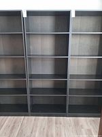 Front view of full-height black engineered wood bookcase