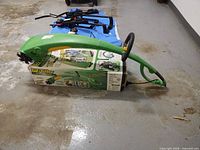 Side view of green EZ-Tiller resting on original box