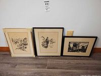 Wide shot showing all three framed artworks side by side