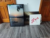 Overall lot showing three of the framed prints leaning against wall