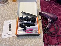 Clipper set opened in box with accessories and Vidal Sassoon hair dryer beside