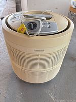 Full view of cylindrical Honeywell 50250 air purifier showing body grilles