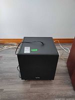 Front view of Infinity BU2 subwoofer with logo and attached power cord