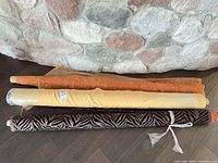 All three fabric bolts stacked against stone wall