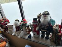 All seven holiday figures lined up on windowsill