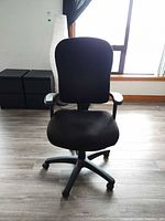 Front view of black Tempur-Pedic office chair with armrests and casters