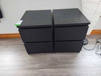 Front view of both black cabinets showing four drawers