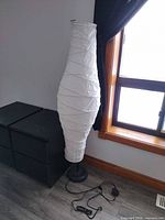 Full view of lamp showing paper shade and base