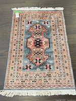 Full view of entire area rug showing size, pattern and fringe