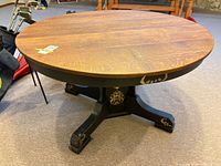 Full view of round wood top table with pedestal base