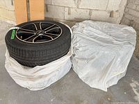 Two of the four Michelin tires, one visible mounted on black machined alloy rim