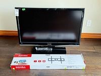 Front view of Sharp LC-42D64U TV, Sonora wall mount box visible