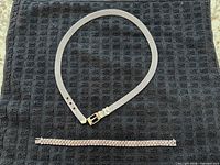 Necklace and bracelet laid flat showing full length and clasps